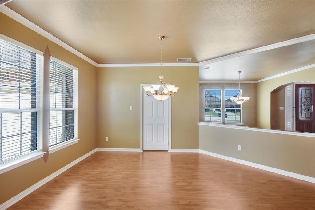 9618 Peach Tree Lane Rowlett, TX 75089 - Photo 6 of 40 a view of an empty room with wooden floor and a window