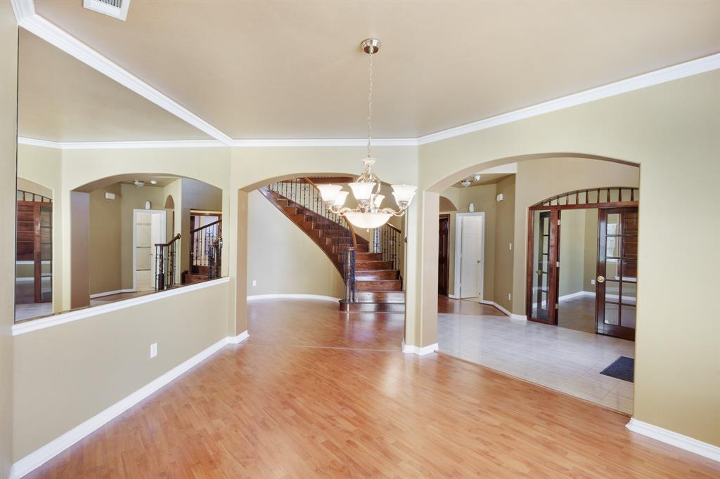 9618 Peach Tree Lane Rowlett, TX 75089 - Photo 7 of 40 a view of a hallway with wooden floor and furniture