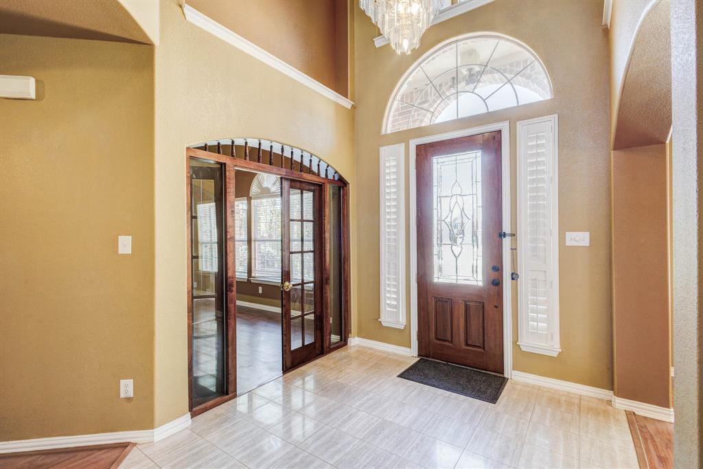 9618 Peach Tree Lane Rowlett, TX 75089 - Photo 8 of 40 a view of a hallway with wooden floor and a livingroom