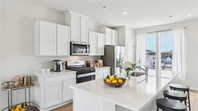 a kitchen with a sink appliances and cabinets