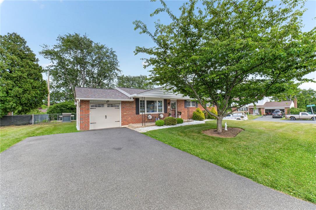 7290 Heather Road Macungie, PA 18062 - Photo 6 of 39 A classic brick facade and tidy landscaping create welcoming curb appeal.