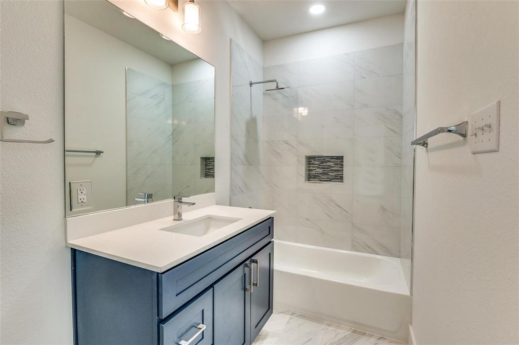 7307 Rubio Place Dallas, TX 75235 - Photo 15 of 17 a bathroom with a sink and a mirror