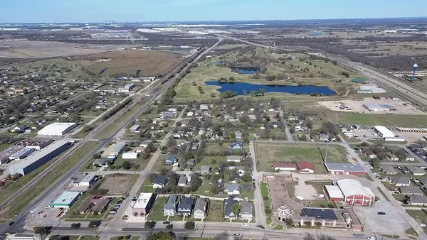 an aerial view of residential houses with outdoor space