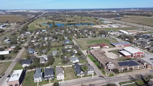 an aerial view of residential houses with outdoor space