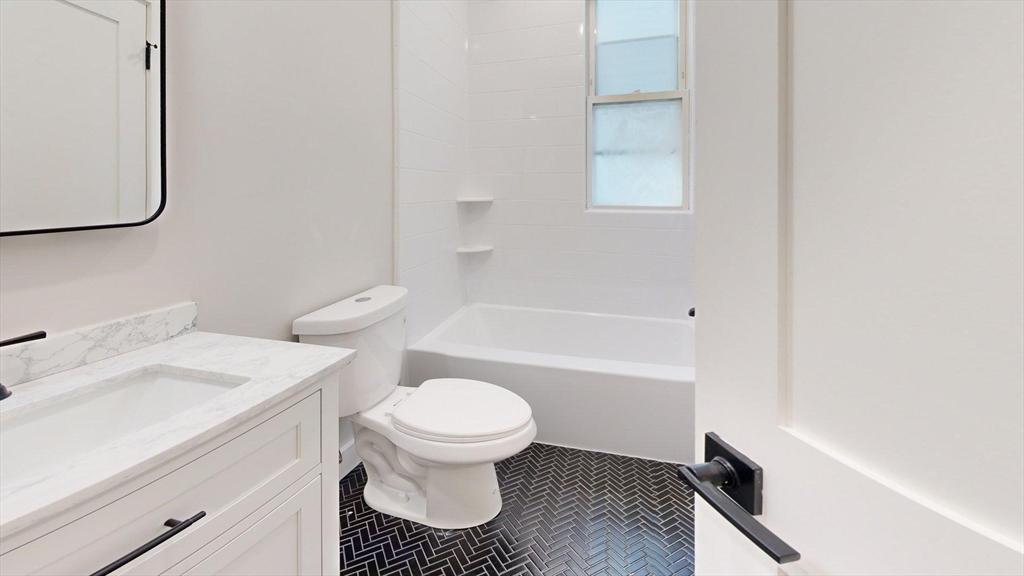 273 Maverick Street, Unit 7 Boston, MA 02128 - Photo 3 of 26 a bathroom with a sink toilet and shower