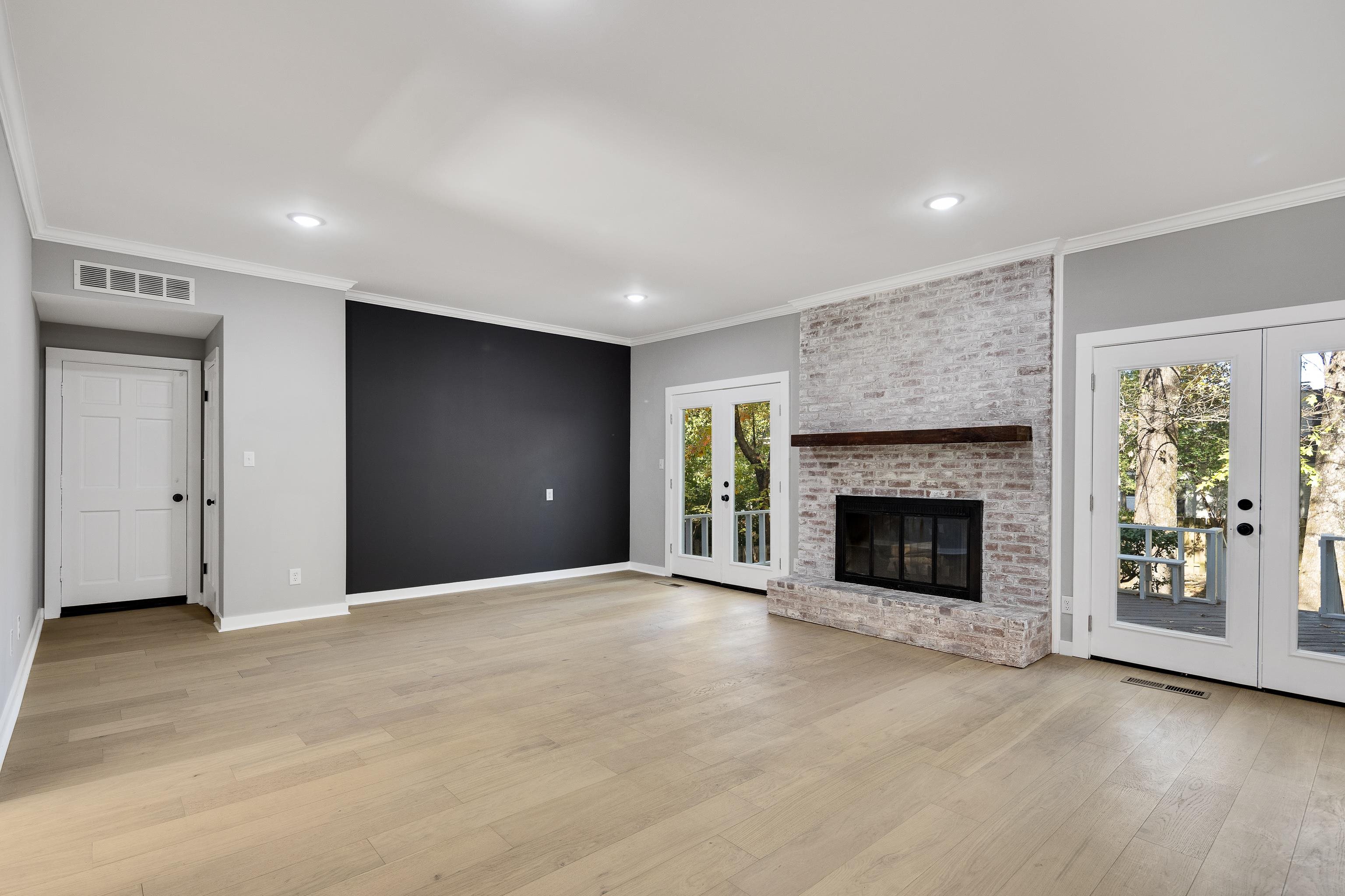 6380 Kirby Ridge Cove Memphis, TN 38119 - Photo 17 of 40 Unfurnished living room with french doors, ornamental molding, plenty of natural light, light wood-type flooring, and recessed lighting