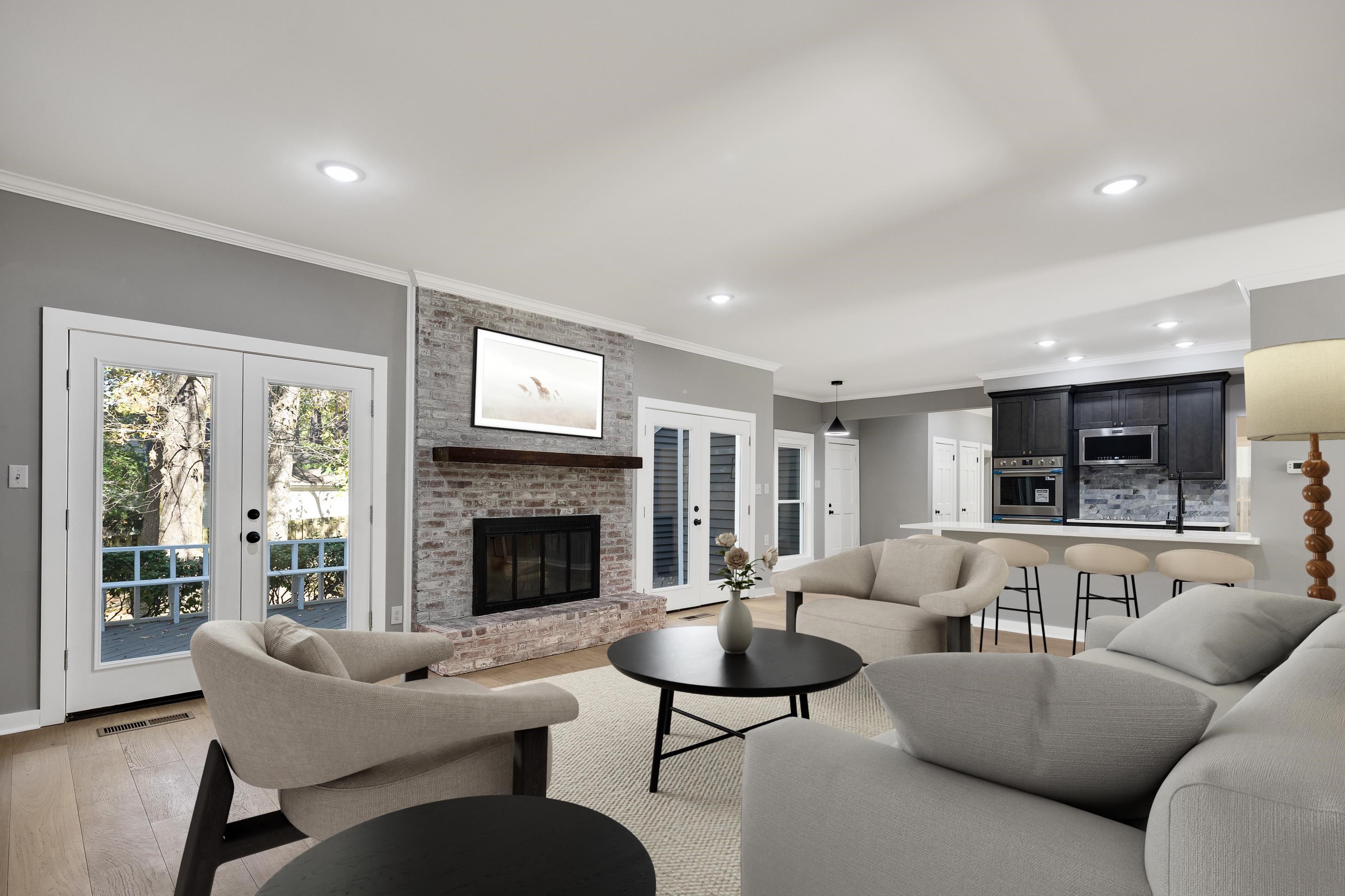 6380 Kirby Ridge Cove Memphis, TN 38119 - Photo 20 of 40 Living area featuring french doors, ornamental molding, a brick fireplace, light wood-type flooring, and recessed lighting