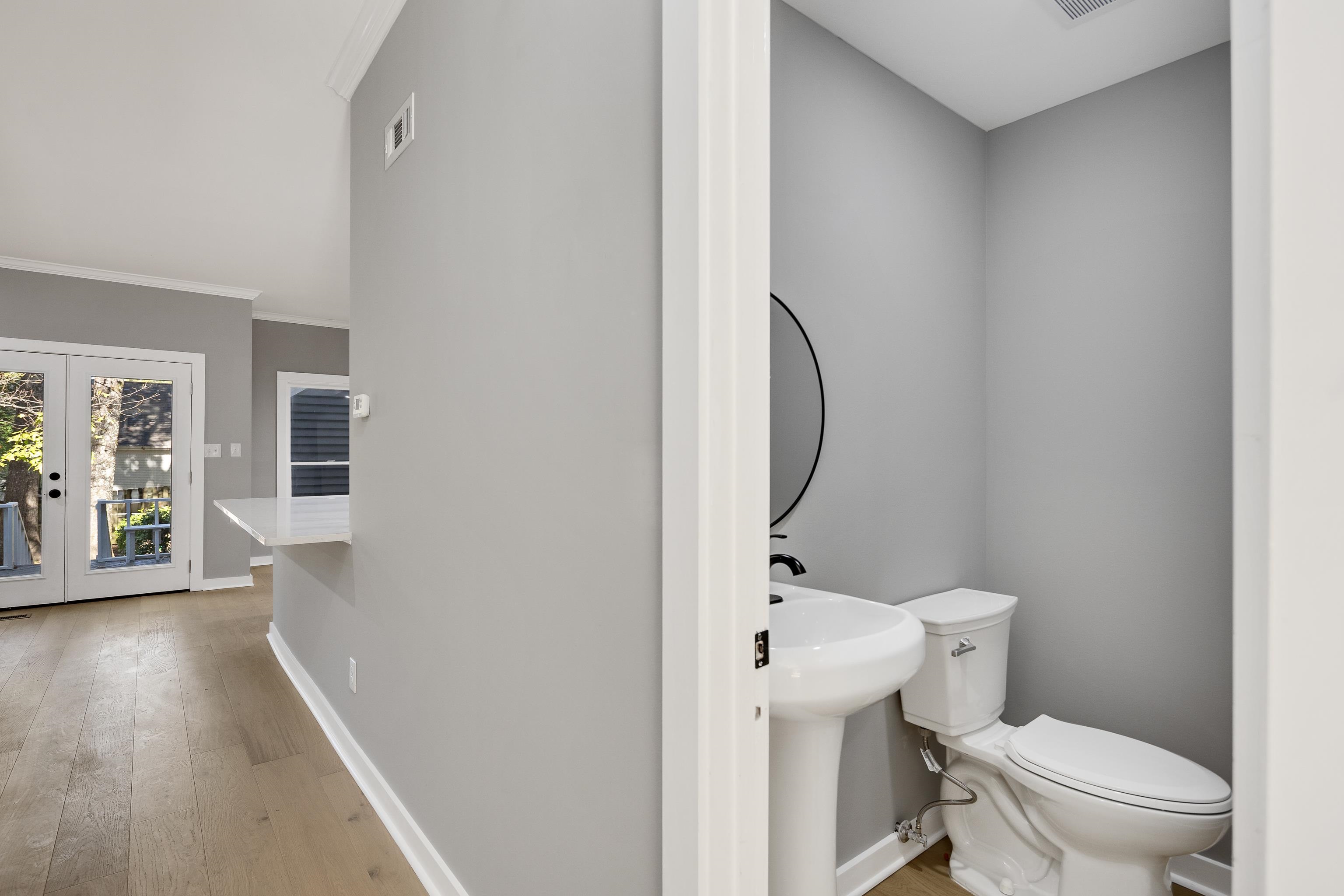 6380 Kirby Ridge Cove Memphis, TN 38119 - Photo 22 of 40 Half bath featuring french doors, light wood-style floors, and crown molding