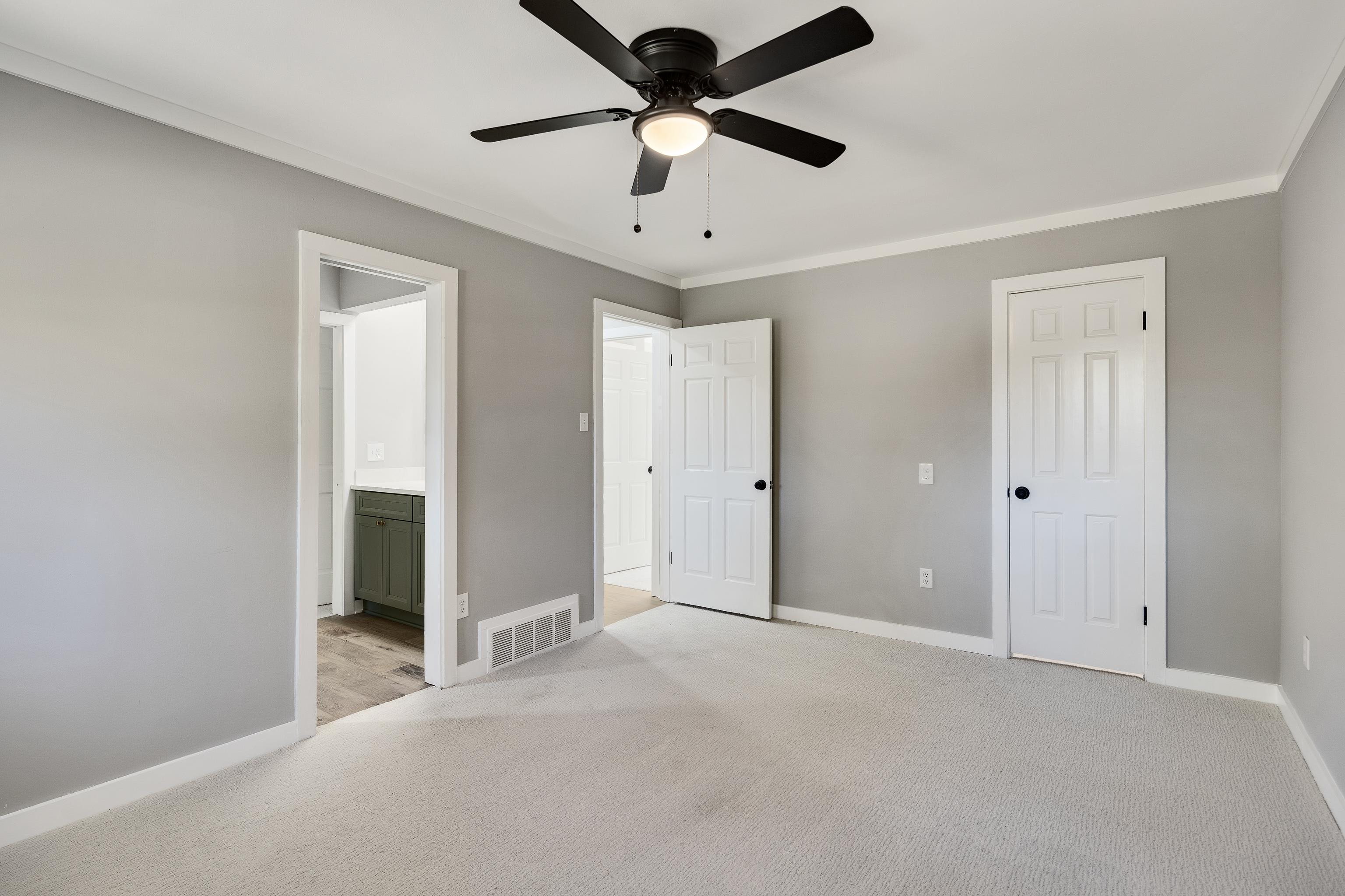 6380 Kirby Ridge Cove Memphis, TN 38119 - Photo 25 of 40 Unfurnished bedroom with light colored carpet, ornamental molding, a ceiling fan, and connected bathroom