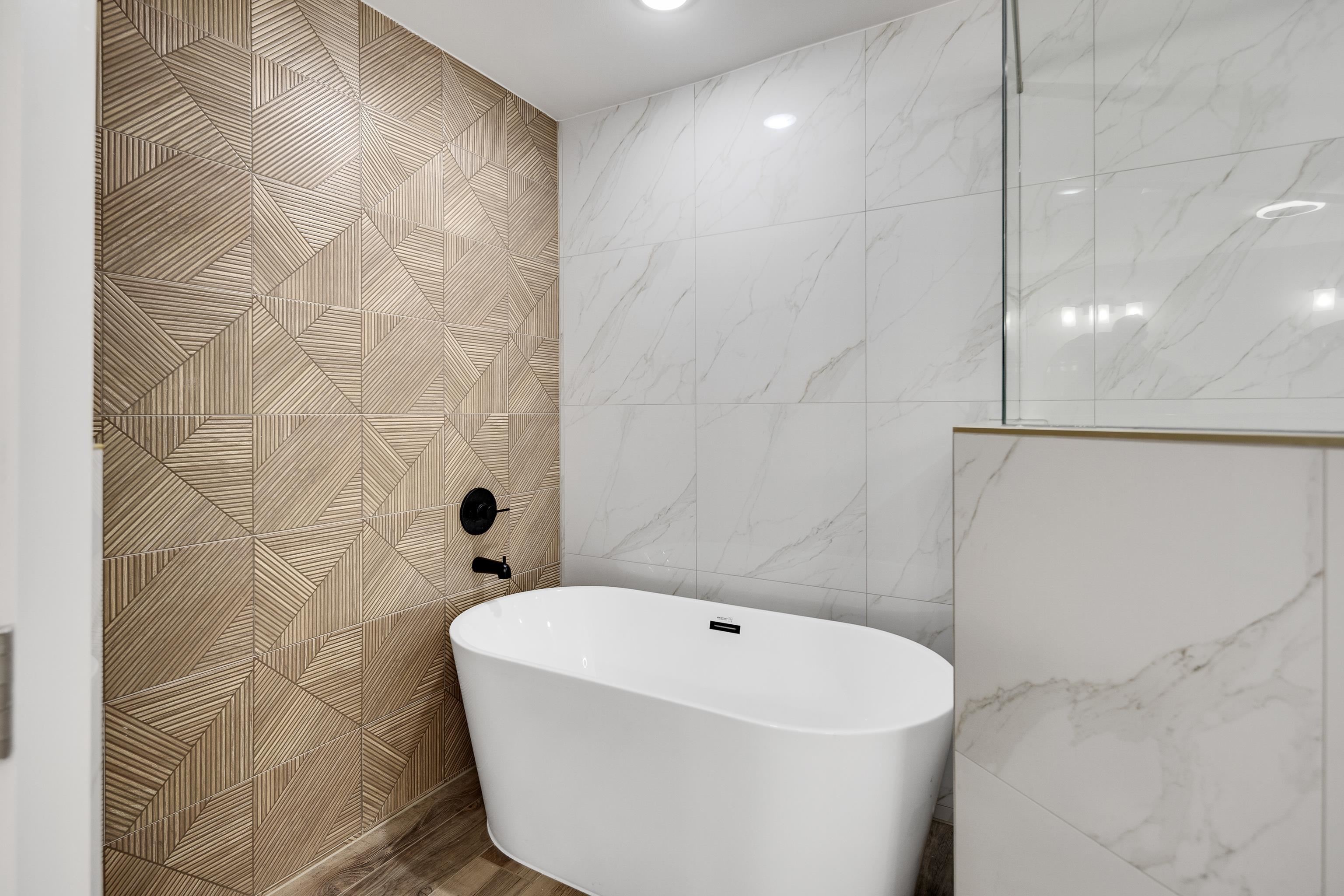 6380 Kirby Ridge Cove Memphis, TN 38119 - Photo 32 of 40 Bathroom featuring tile walls and a freestanding bath