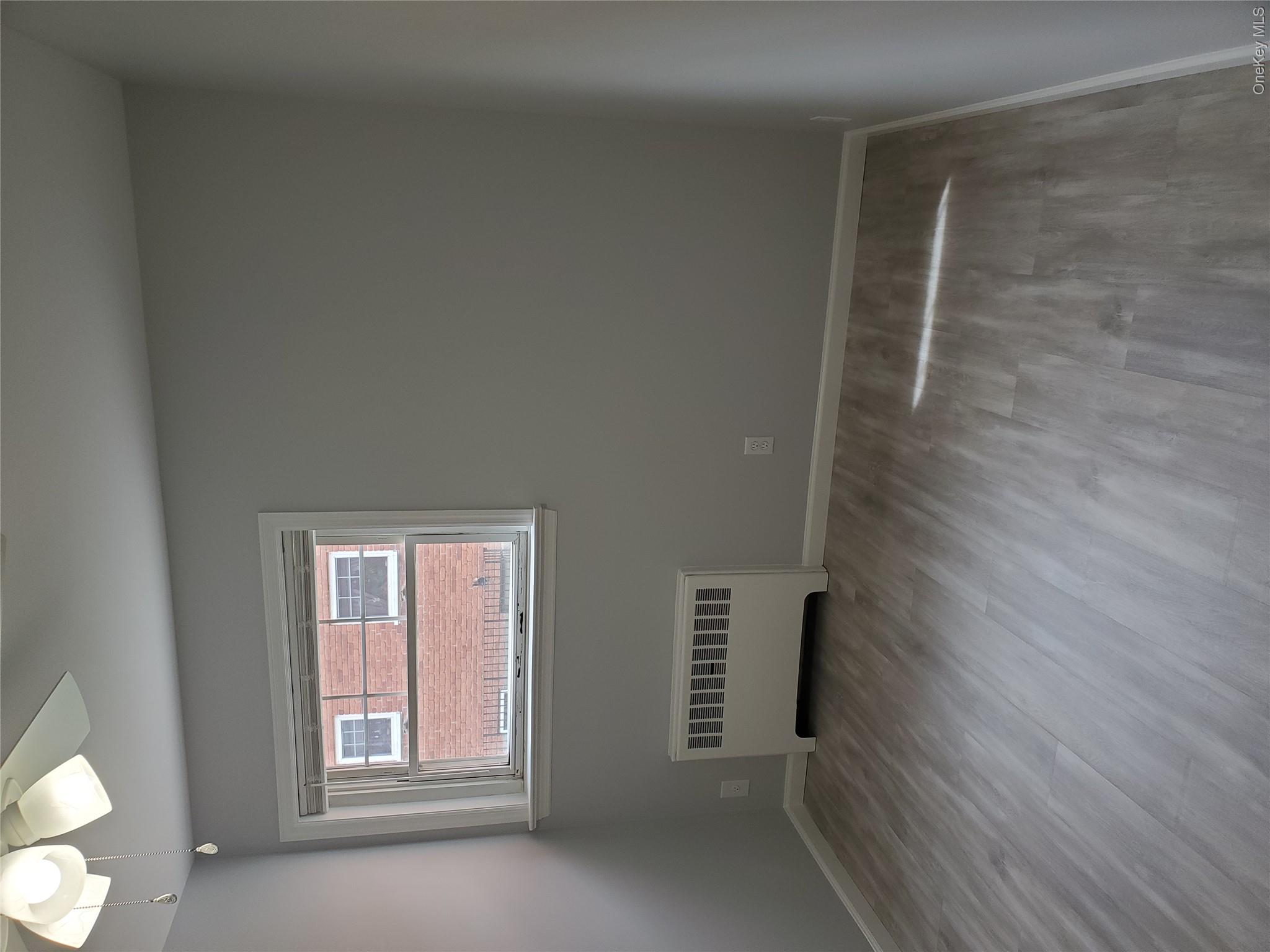 1879 Crompond Road, Unit A21 Peekskill, NY 10566 - Photo 11 of 20 wooden floor in an empty room with a window