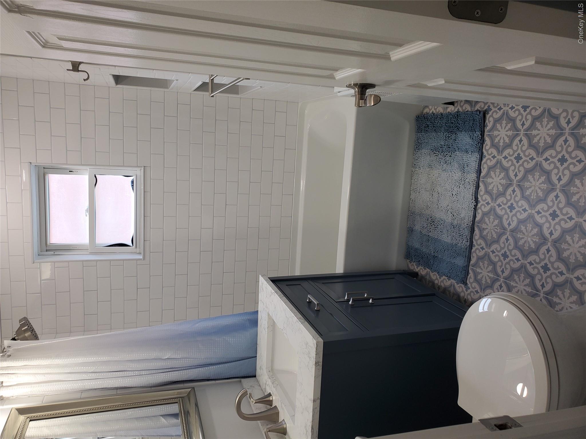 1879 Crompond Road, Unit A21 Peekskill, NY 10566 - Photo 15 of 20 a bathroom with a sink a toilet a mirror and shower