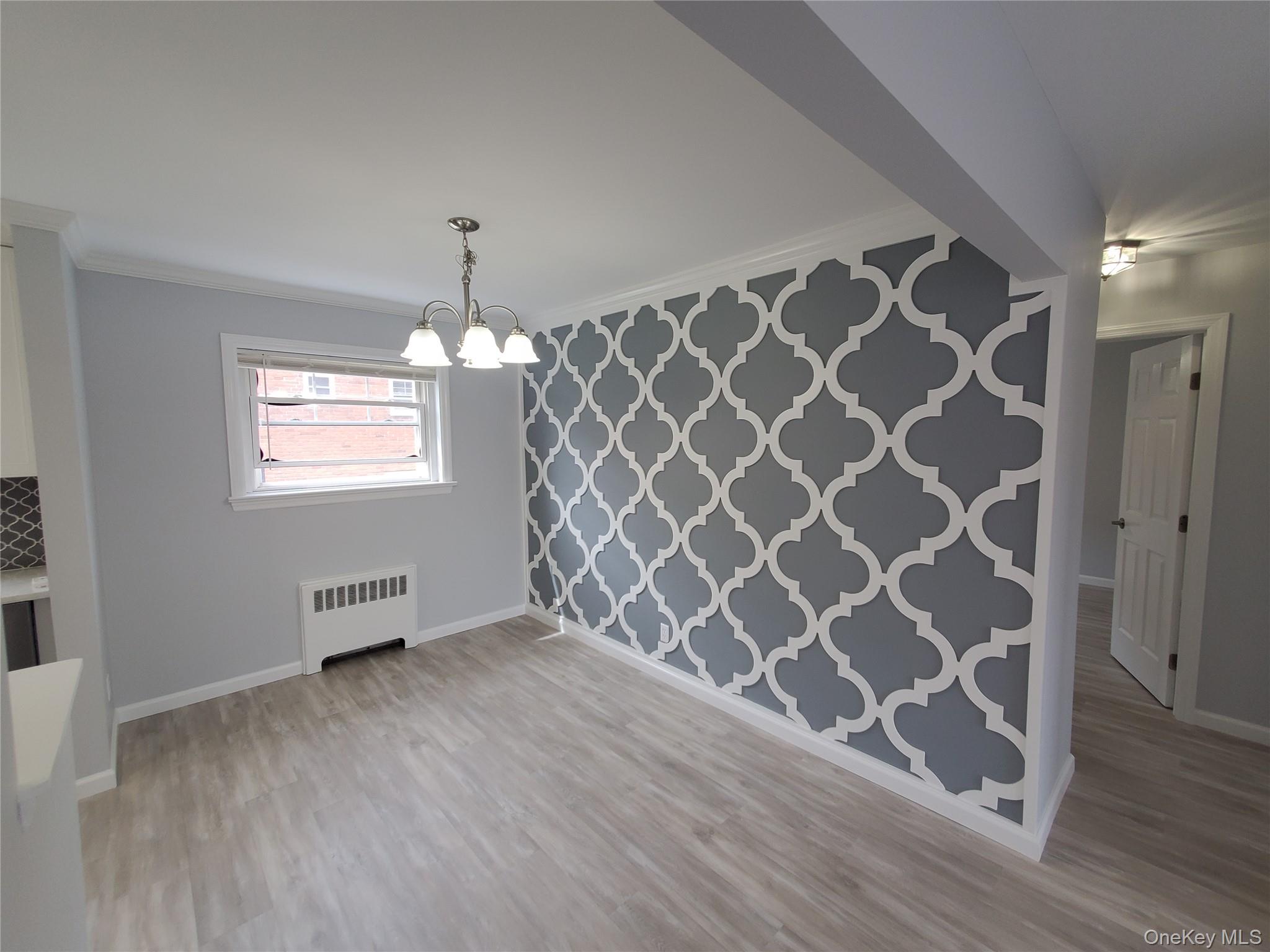 1879 Crompond Road, Unit A21 Peekskill, NY 10566 - Photo 5 of 20 an empty room with wooden floor and windows