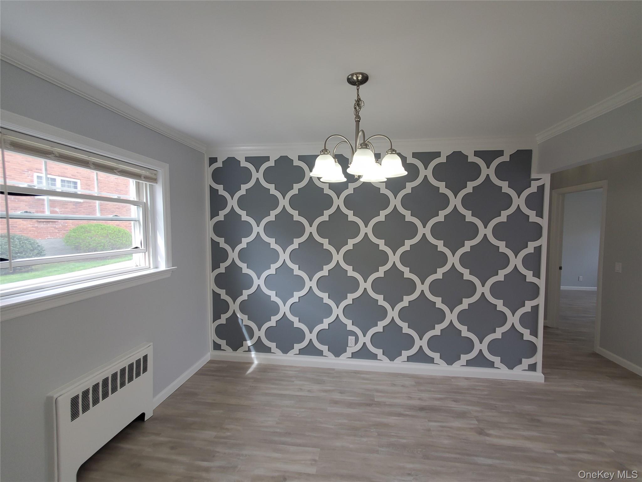 1879 Crompond Road, Unit A21 Peekskill, NY 10566 - Photo 6 of 20 a view of an empty room with wooden floor and a window