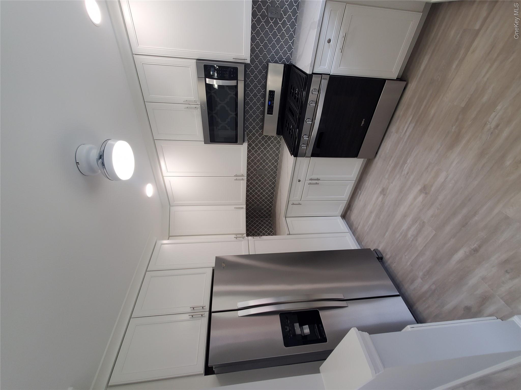 1879 Crompond Road, Unit A21 Peekskill, NY 10566 - Photo 7 of 20 a kitchen with granite countertop a refrigerator and a stove top oven