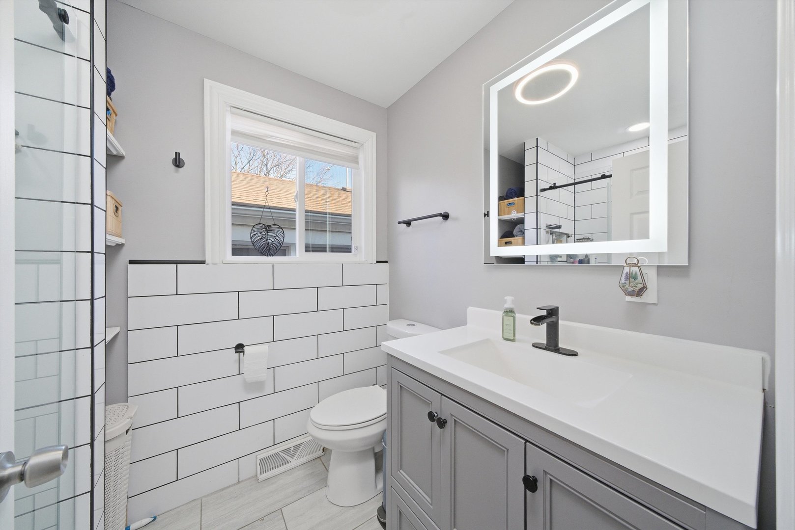 4305 South Wood Street Chicago, IL 60609 - Photo 13 of 22 a bathroom with a sink a toilet and a mirror