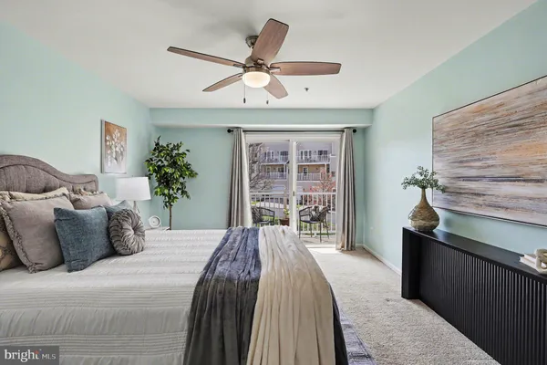 a bedroom with a large bed and a chandelier