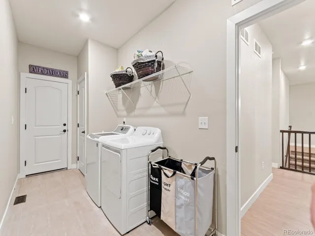 a utility room with closet dryer and washer