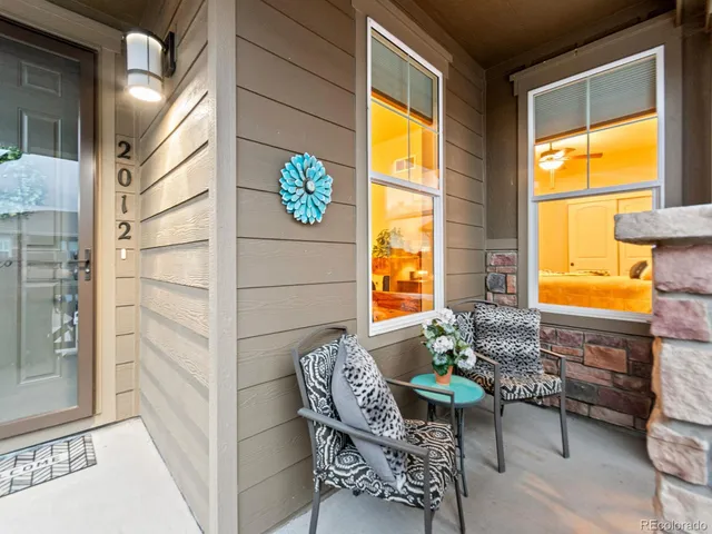a balcony with table and chairs