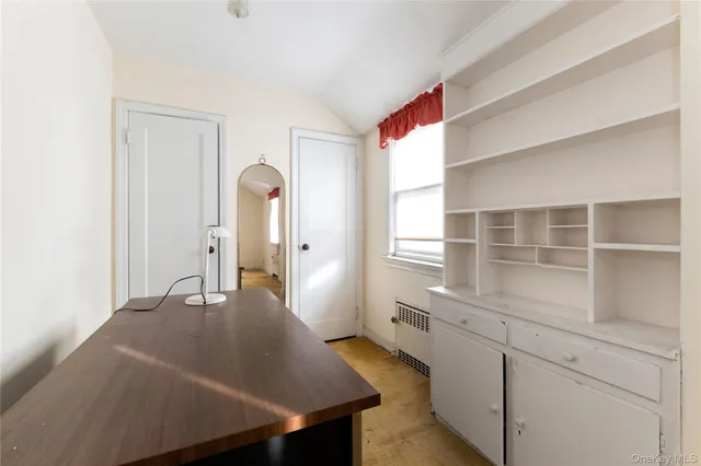 a room with a bed and cabinets