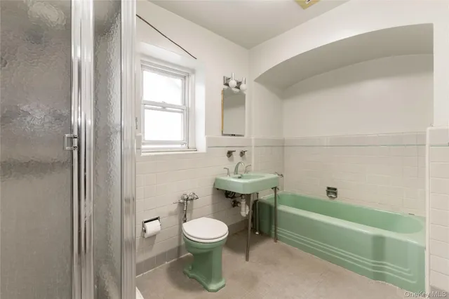 a bathroom with a sink a toilet and bathtub