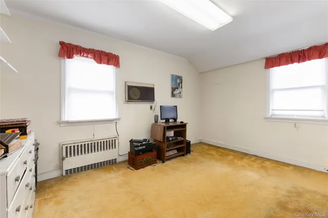 a bedroom with furniture and a window