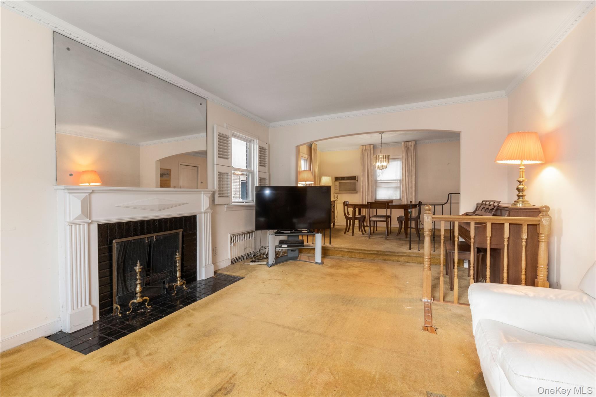 185-47 80th Road Queens, NY 11366 - Photo 2 of 20 a living room with furniture a fireplace and a flat screen tv