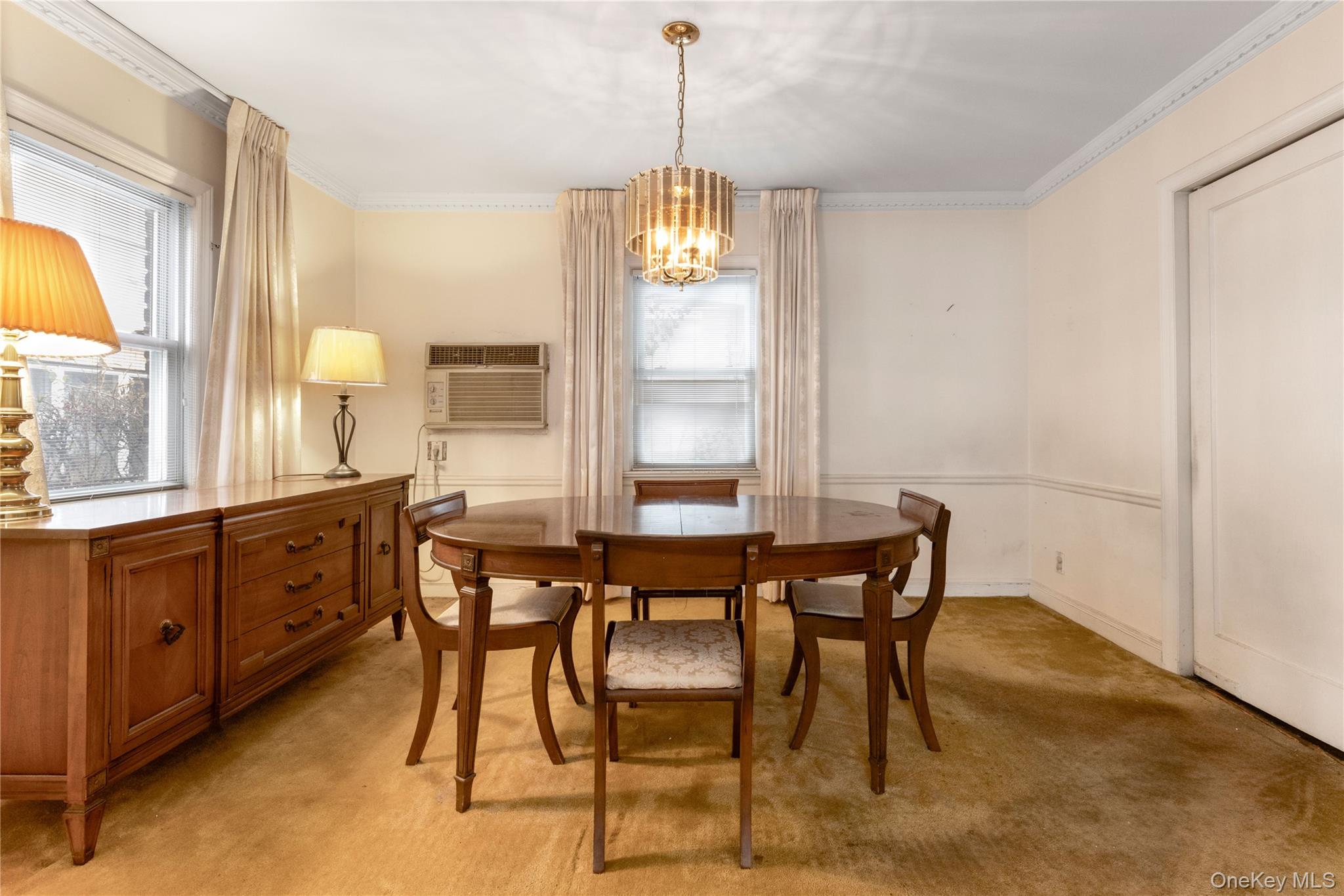 185-47 80th Road Queens, NY 11366 - Photo 3 of 20 a dining room with furniture a chandelier and window