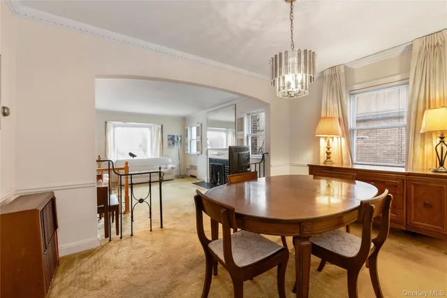 a dining room with furniture window and wooden floor