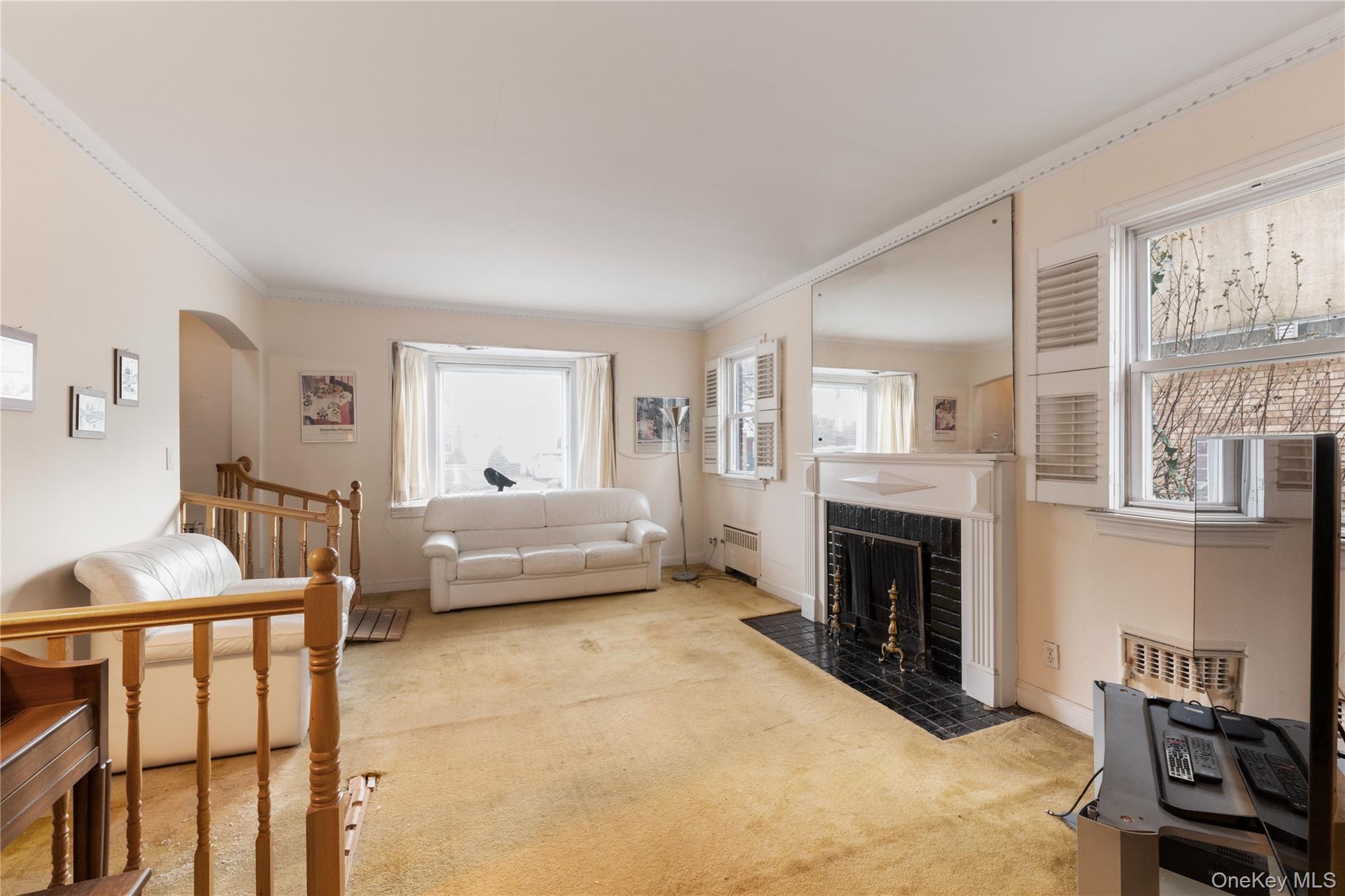 185-47 80th Road Queens, NY 11366 - Photo 5 of 20 a bedroom with furniture and a fireplace