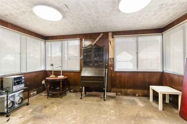 a room with furniture and two window