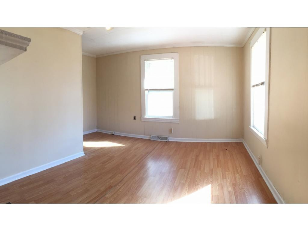 1333 Hampton Road Eden, NC 27288 - Photo 12 of 23 an empty room with wooden floor and windows