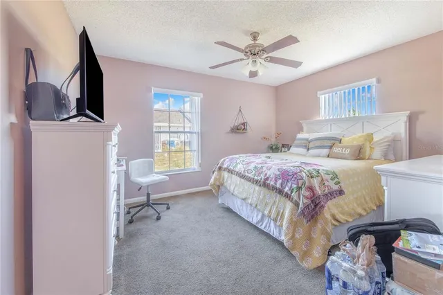 a bedroom with a bed a couch and dresser