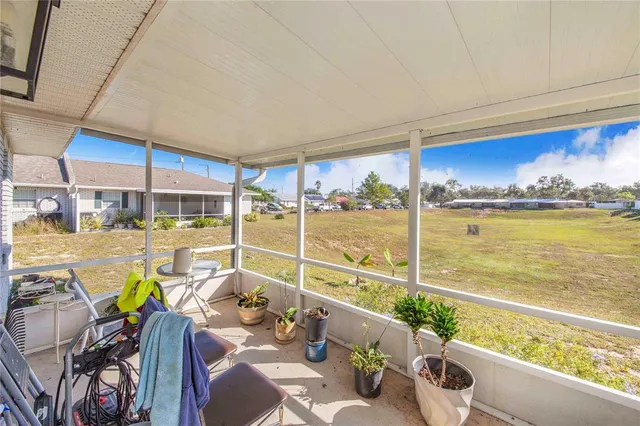 a view of a balcony with chairs and a table
