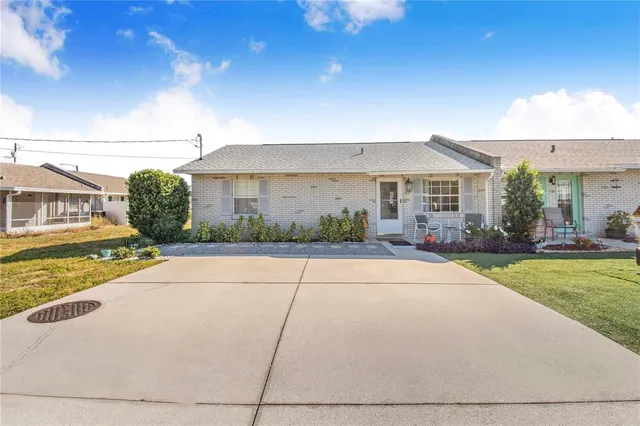 a view of a house with a garden and pathway