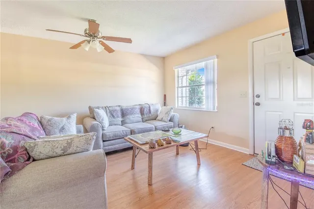 a living room with furniture and a wooden floor