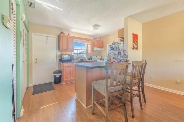 a dining room with furniture and a kitchen view
