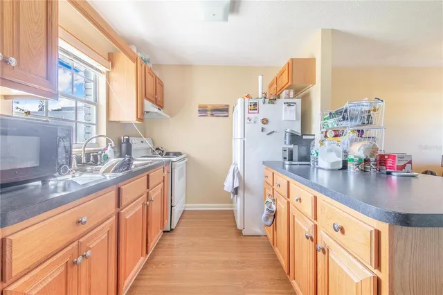 a kitchen with stainless steel appliances a sink and a large window