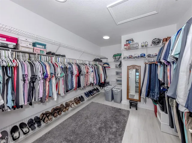 a spacious bathroom with a granite countertop sink a mirror and a shower