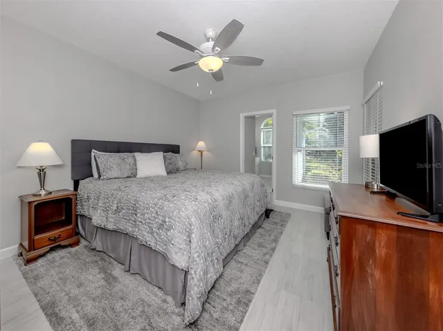 a spacious bathroom with a toilet sink and mirror