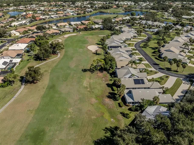 an aerial view of a house with a swimming pool yard and lake view
