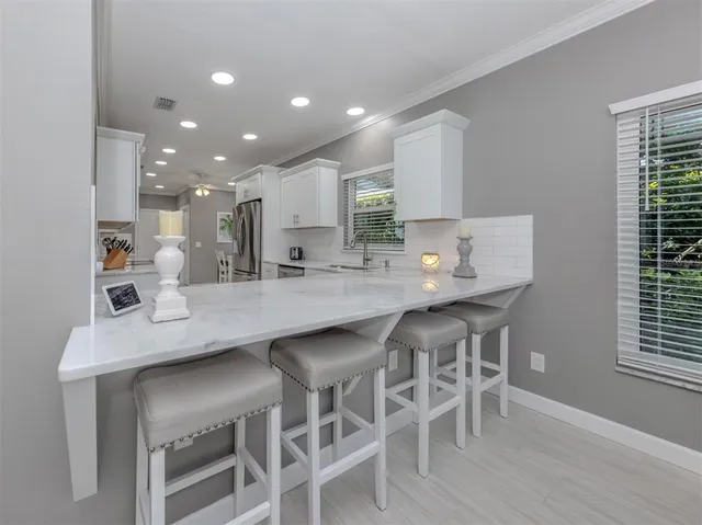 a dining room with furniture a chandelier and wooden floor