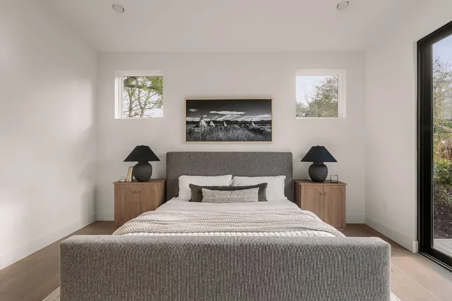 a bedroom with a large bed and a potted plant