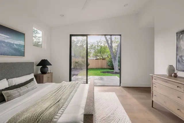 a bedroom with a bed and a painting on the wall