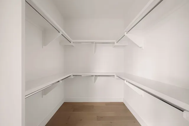 a view of walk in closet with empty racks