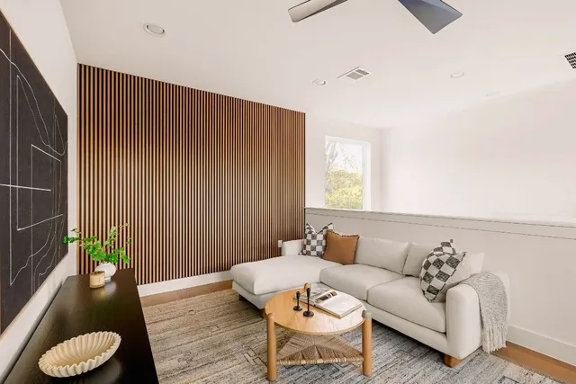a living room with furniture and a potted plant