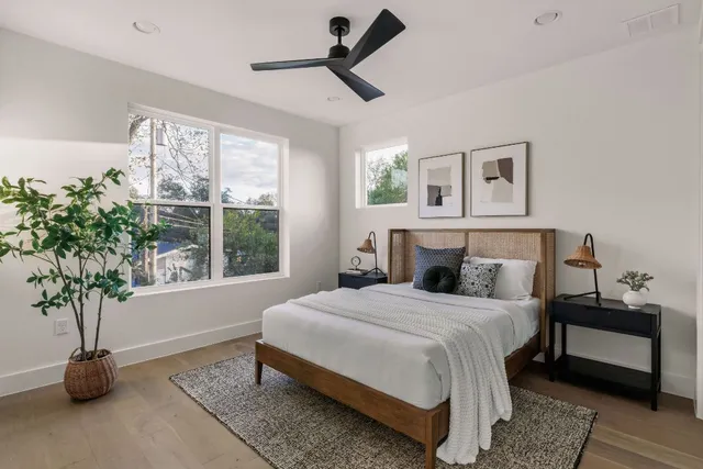 a bedroom with a bed and a potted plant