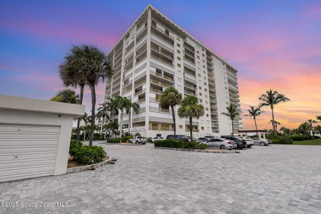 a view of a tall building with a yard