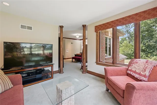 a living room with furniture a rug and a window