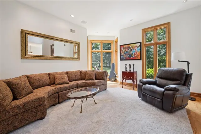a view of a big house with a big yard and large trees